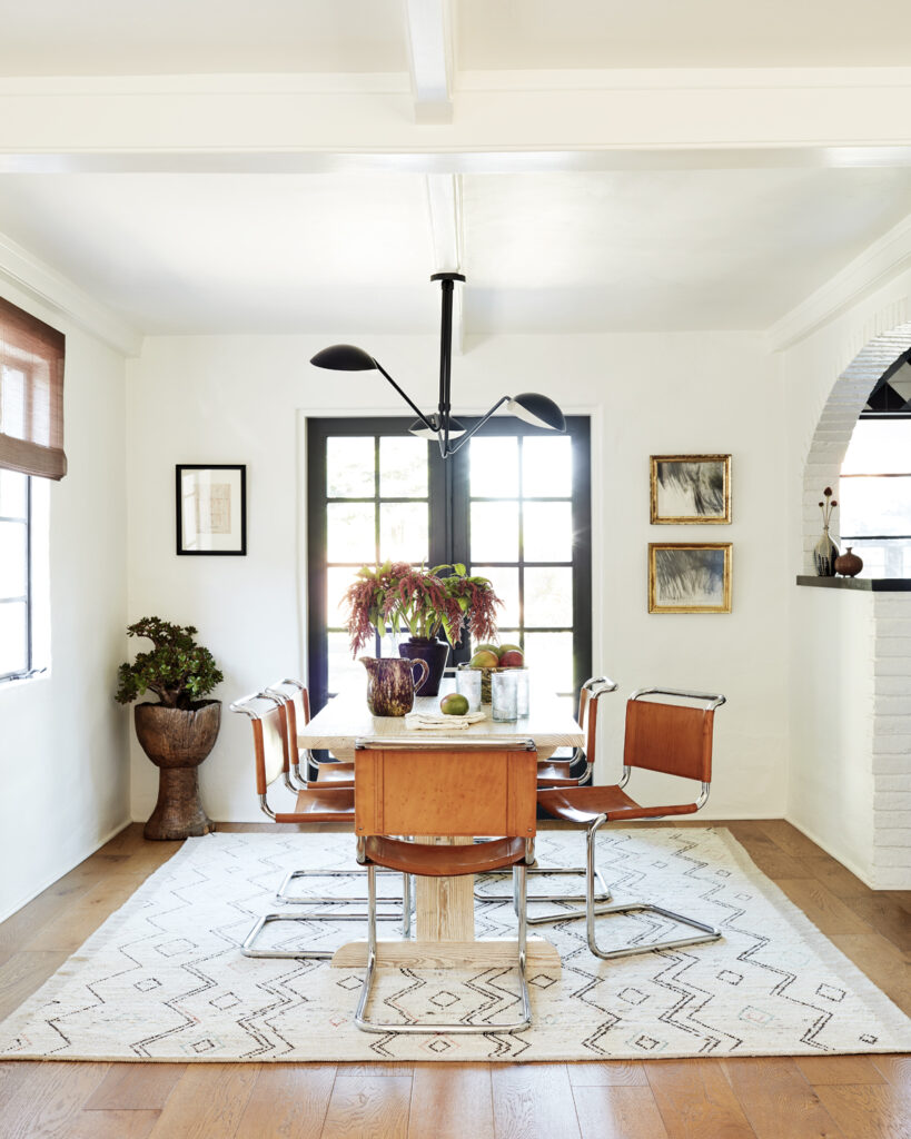 In the dining room, vintage leather chairs sit atop a rug from Jamal’s Rug Collection in L.A.