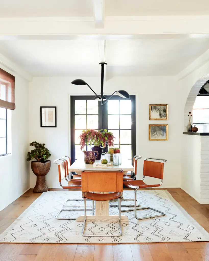 In the dining room, vintage leather chairs sit atop a rug from Jamal’s Rug Collection in L.A.